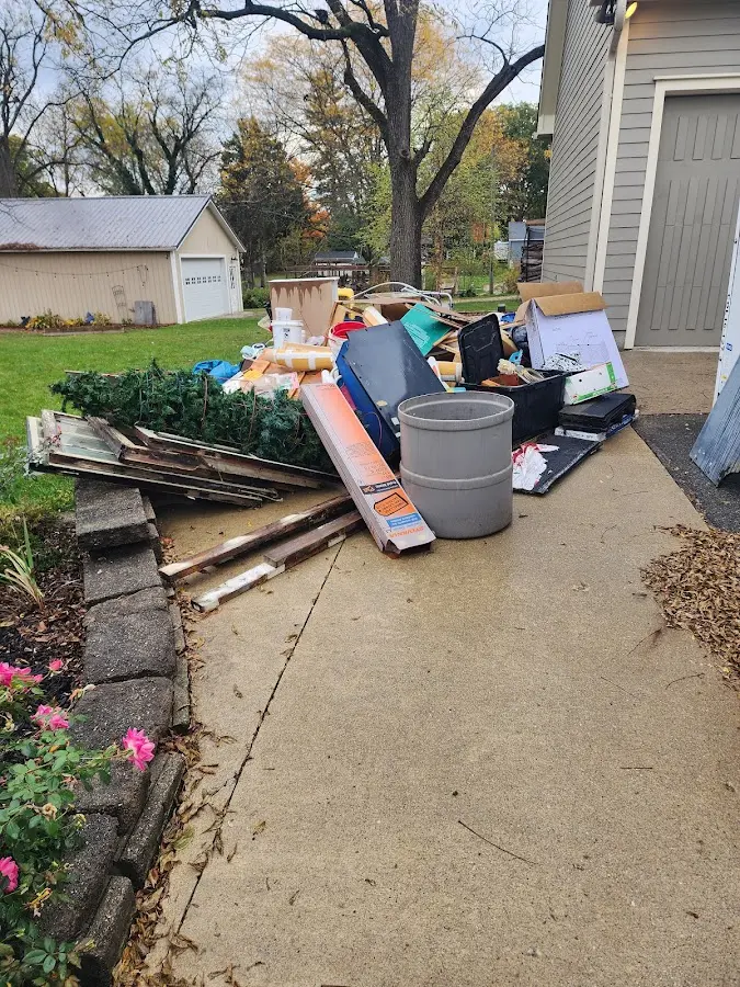Dumpster being loaded with debris for 3 Yard Dumpster Rental in Rio Bravo